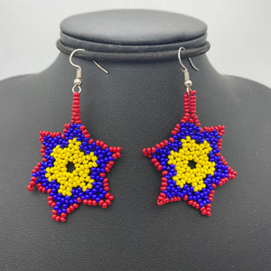 Dangling red, blue and yellow snowflake shaped earrings