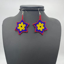 Cargar imagen en el visor de la galería, Dangling red, blue and yellow snowflake shaped earrings
