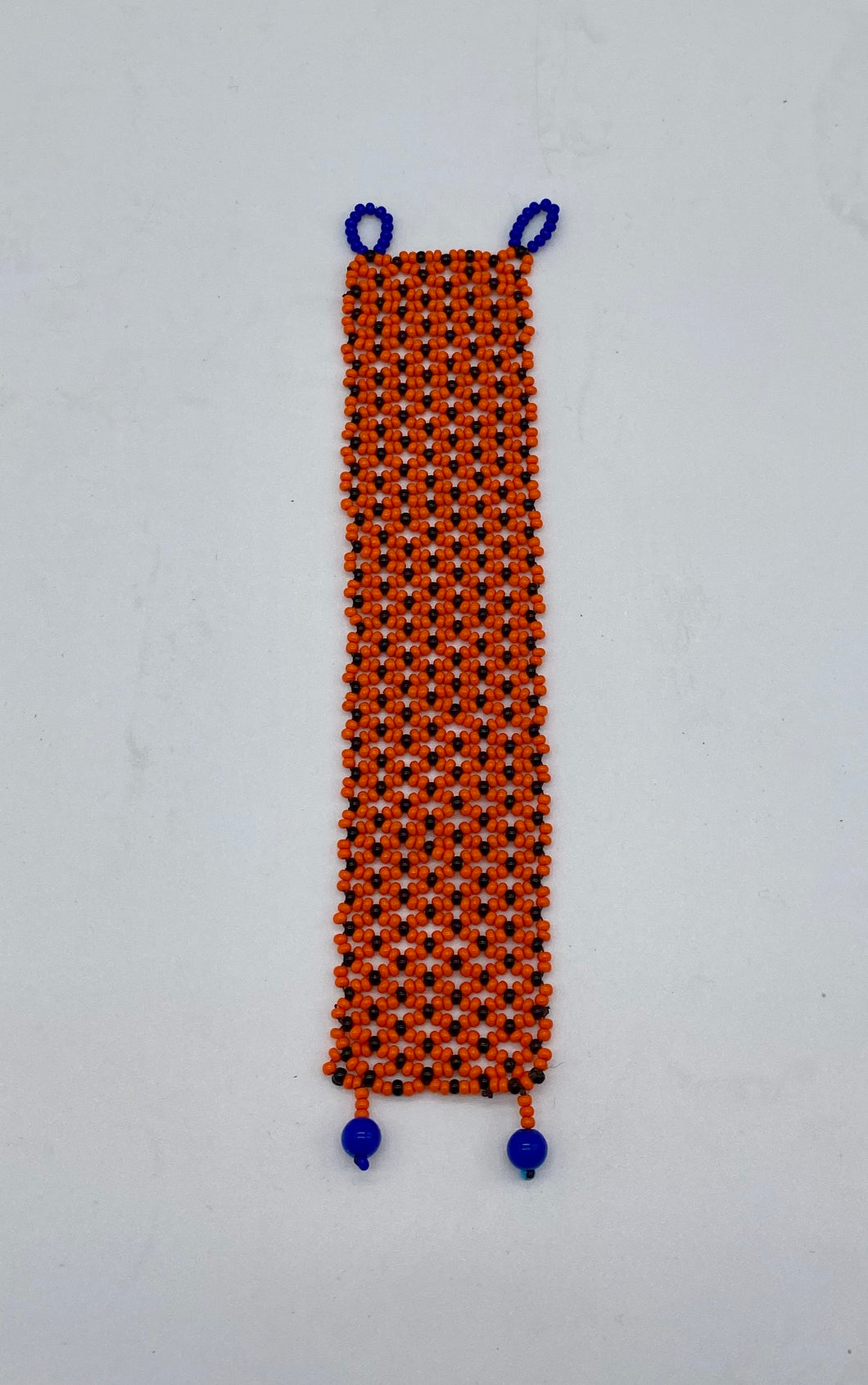 Delicate orange bracelet with blue clasps
